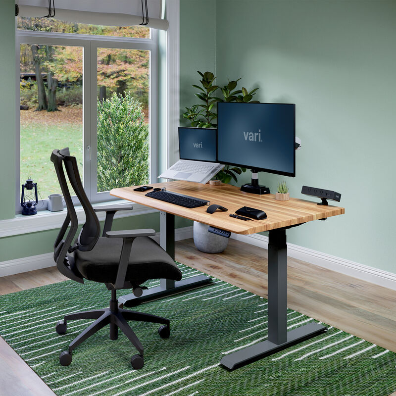 Electric Standing Desk with ComfortEdge in 48x30 Butcher Block in lowered position at home image number null